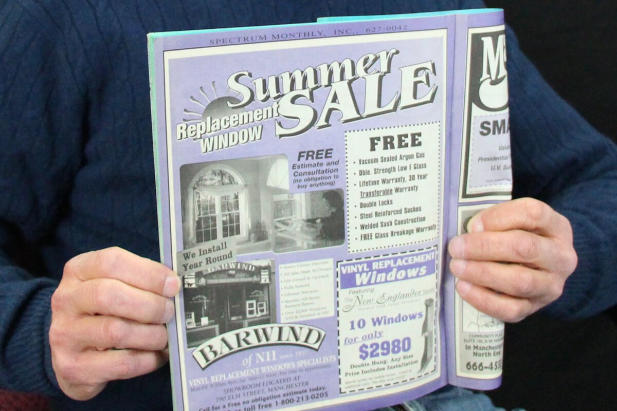 holding an original Spectrum Monthly Direct Mail Coupon Book